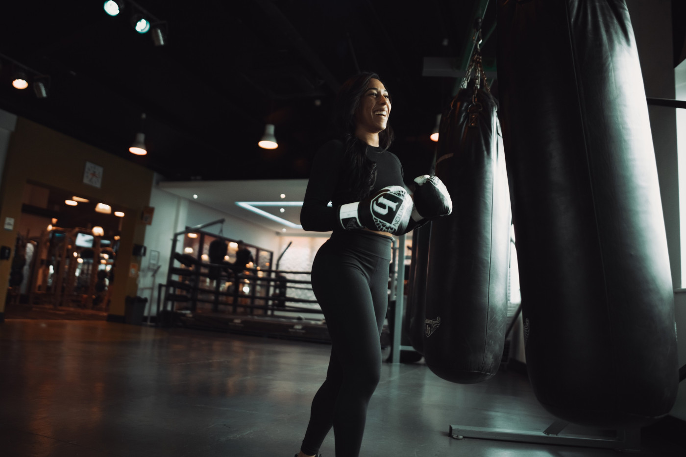 Woman in Gym with Punching Bag